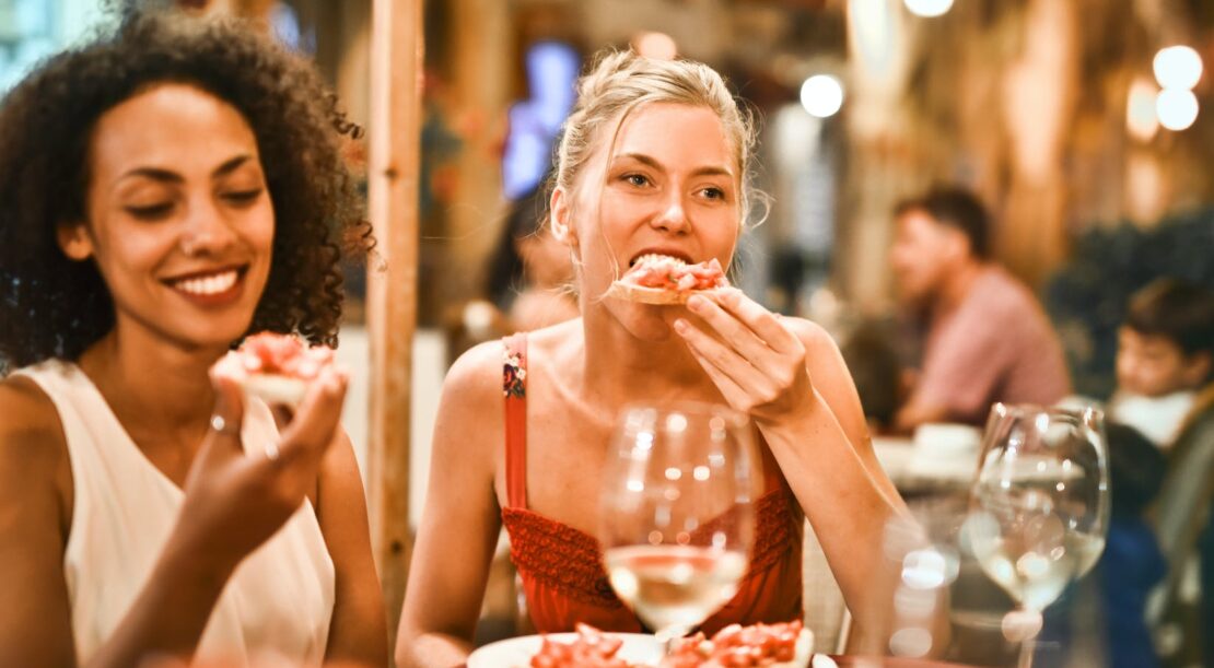 woman eating bruschetta